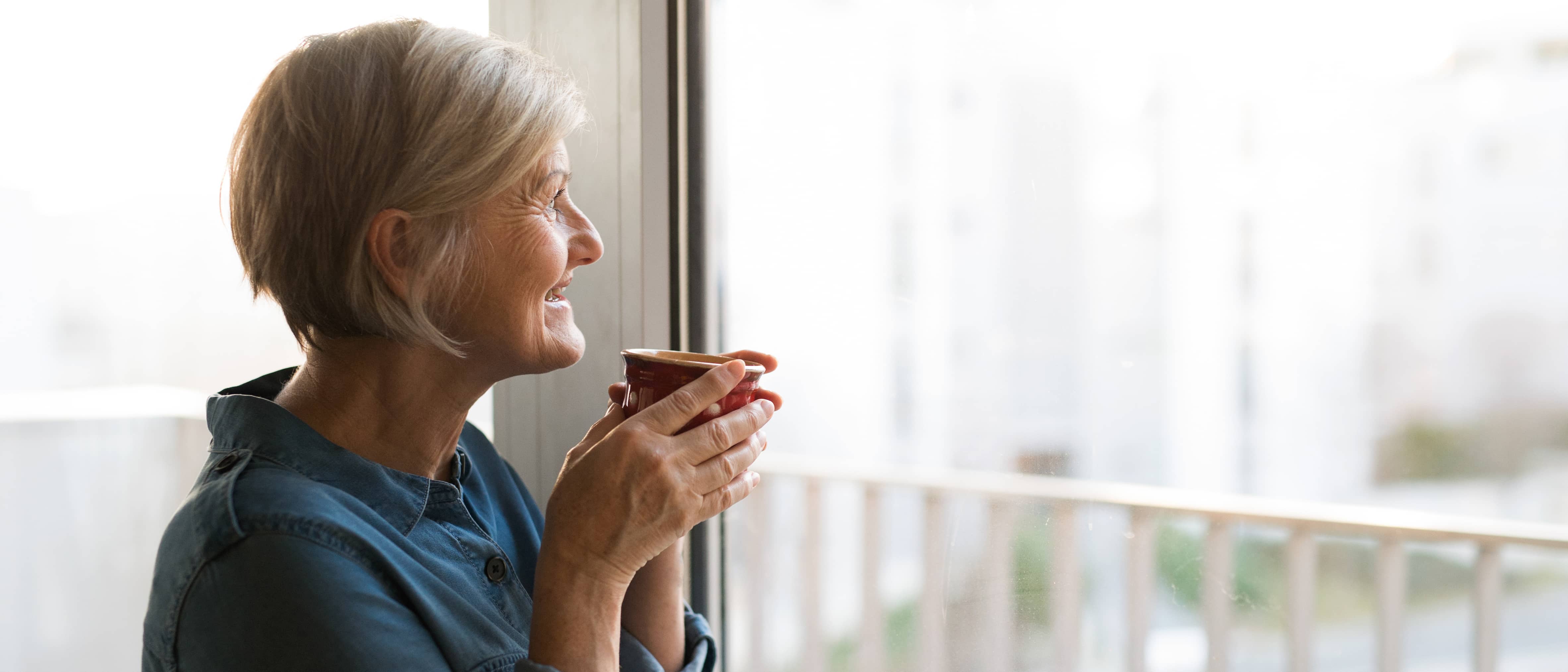 vrouw kijkt uit het raam 